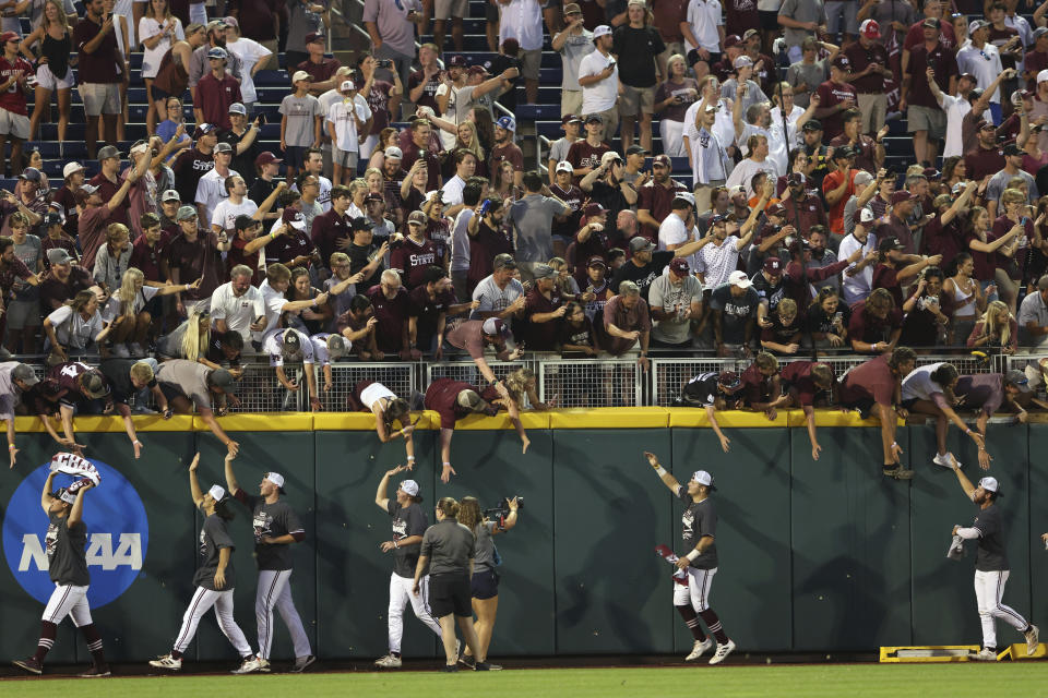 Mississippi State celebrates with fans after winning the College World Series 9-0 against Vanderbilt after the deciding Game 3 Wednesday, June 30, 2021, in Omaha, Neb. (AP Photo/Rebecca S. Gratz)