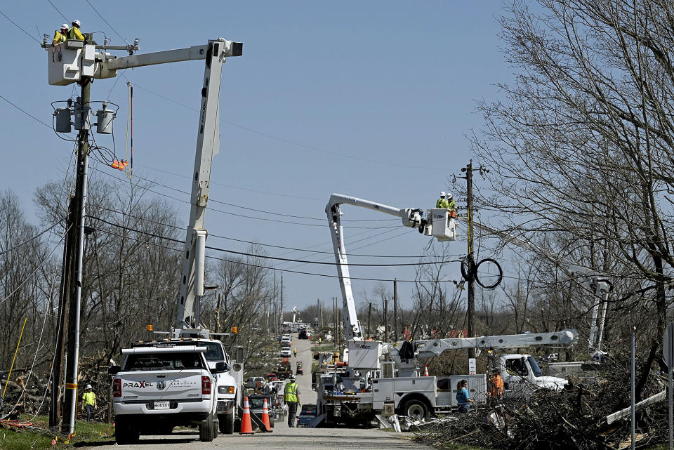 Lineman work to reestablish the power in a neighborhood that was damaged by a recent tornado on Monday, April 3, 2023, in Sullivan, Ind. (Joseph C. Garza/The Tribune-Star via AP)