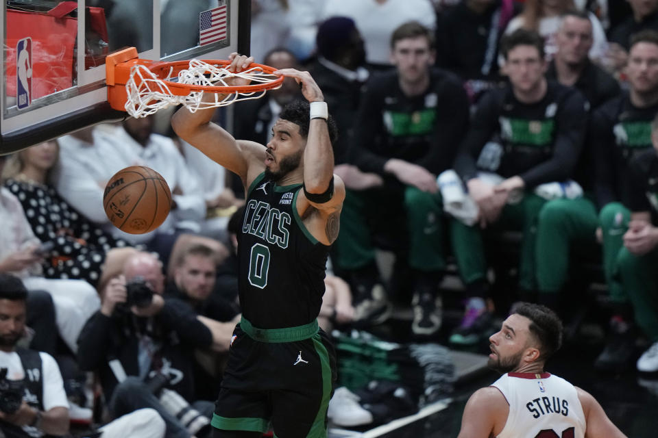 Boston Celtics forward Jayson Tatum (0) dunks the ball over Miami Heat guard Max Strus (31) during the second half of Game 3 of the NBA basketball playoffs Eastern Conference finals, Sunday, May 21, 2023, in Miami. (AP Photo/Lynne Sladky)