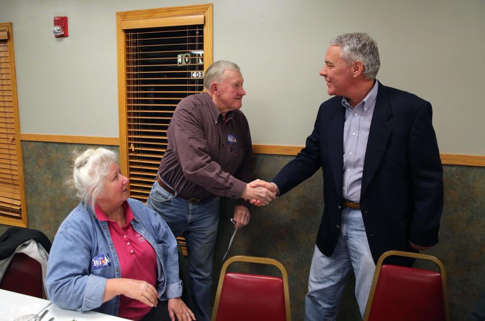 In this Jan. 24, 2014 photo, current GOP U.S. Senate primary candidate Ken Buck shakes hands with supporter Dale Gustafson, chairman of the Colorado Conservative Union, as Gustafson's wife Donna sits at left, during a campaign dinner event at Johnson's Corner, a truck stop and diner in Johnstown, Colo. Buck narrowly lost a 2010 Senate bid after being hammered for statements that angered some women and gays. Now his candidacy will be a test of whether a tea party favorite can do better in 2014. (AP Photo/Brennan Linsley)