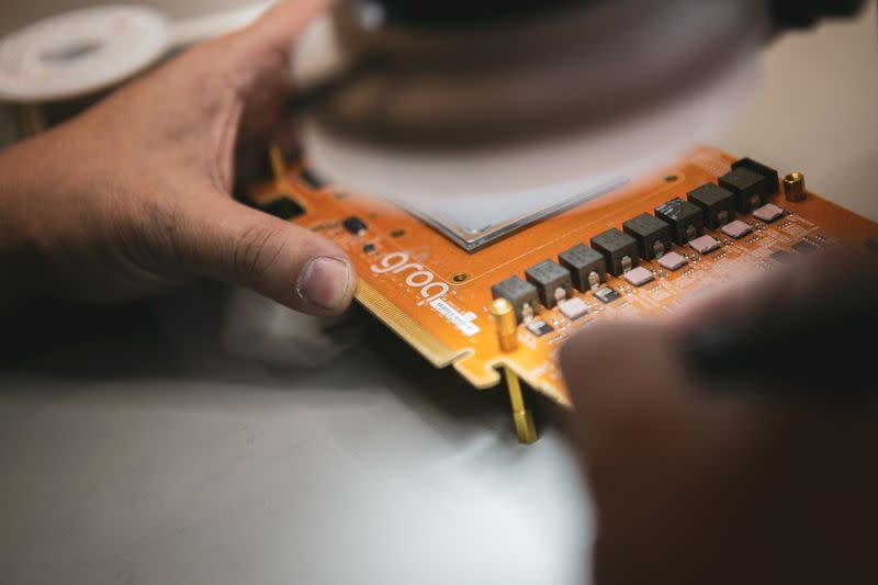 Engineer of Groq, a Silicon Valley AI chip design startup, works on a GroqCard, in this undated handout image