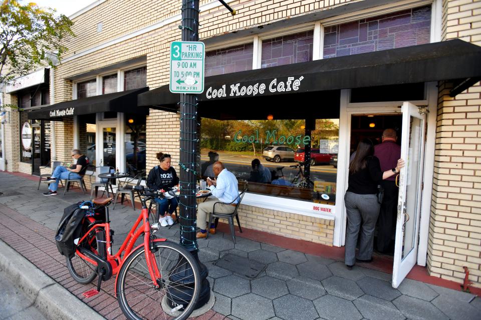 Customers diner outside Cool Moose Cafe on Park Street on Wednesday morning.