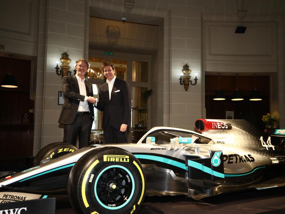 INEOS Founder and Chairman Sir Jim Ratcliffe (L) and Toto Wolff, Team Principal & CEO of The Mercedes AMG-PETRONAS F1 Team (R) pose for a photo with a Mercedes F1 car.