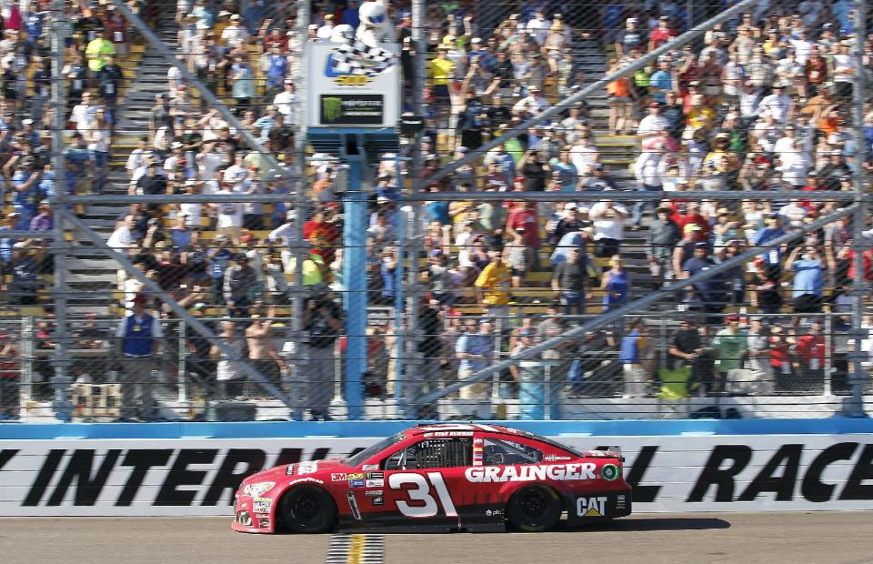 Ryan Newman takes the checkered flag to win the NASCAR Cup Series auto race at Phoenix International Raceway, Sunday, March. 19, 2017, in Avondale, Ariz. (AP Photo/Ralph Freso)