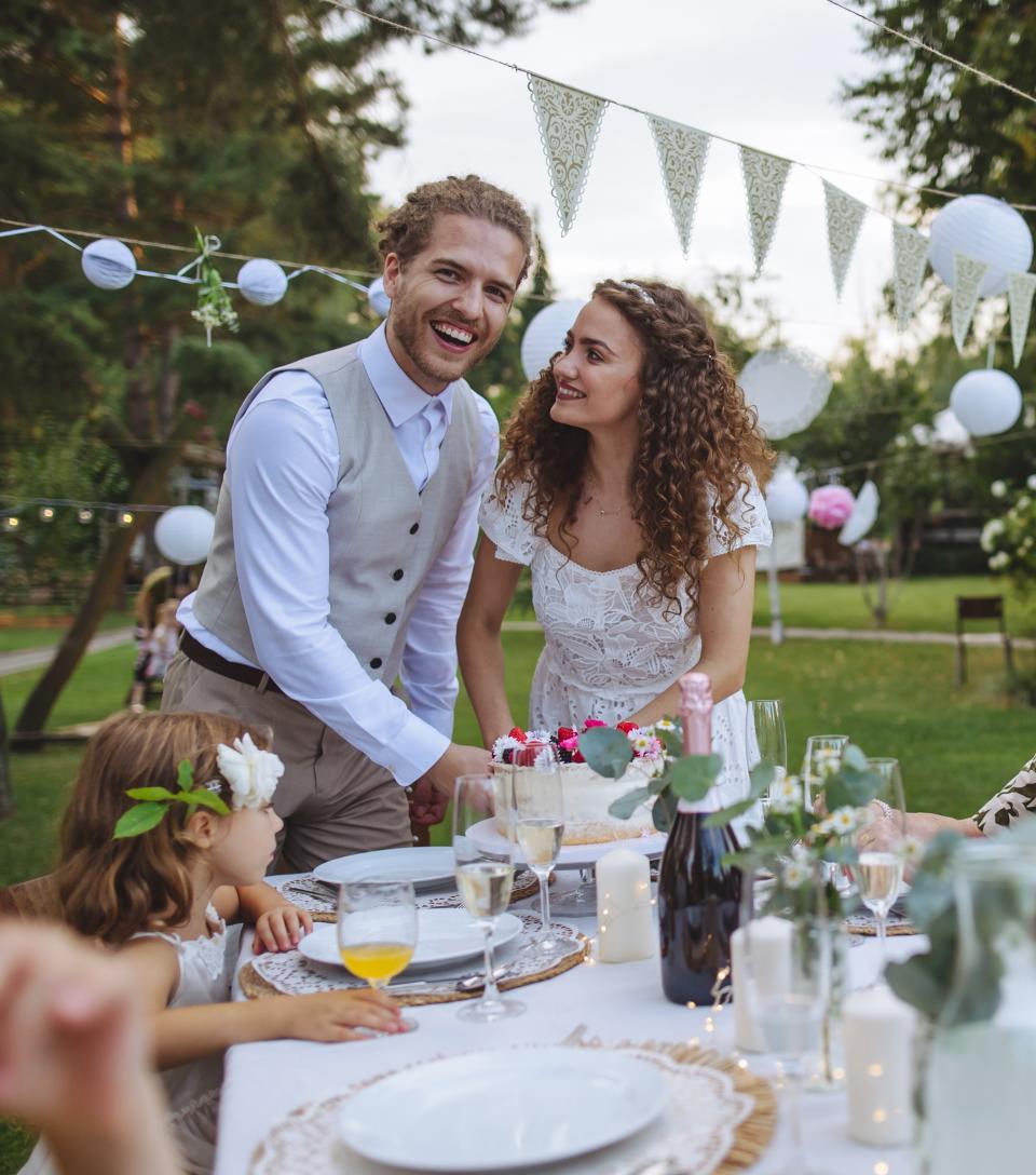 A bride looks lovingly at her groom at their wedding reception.