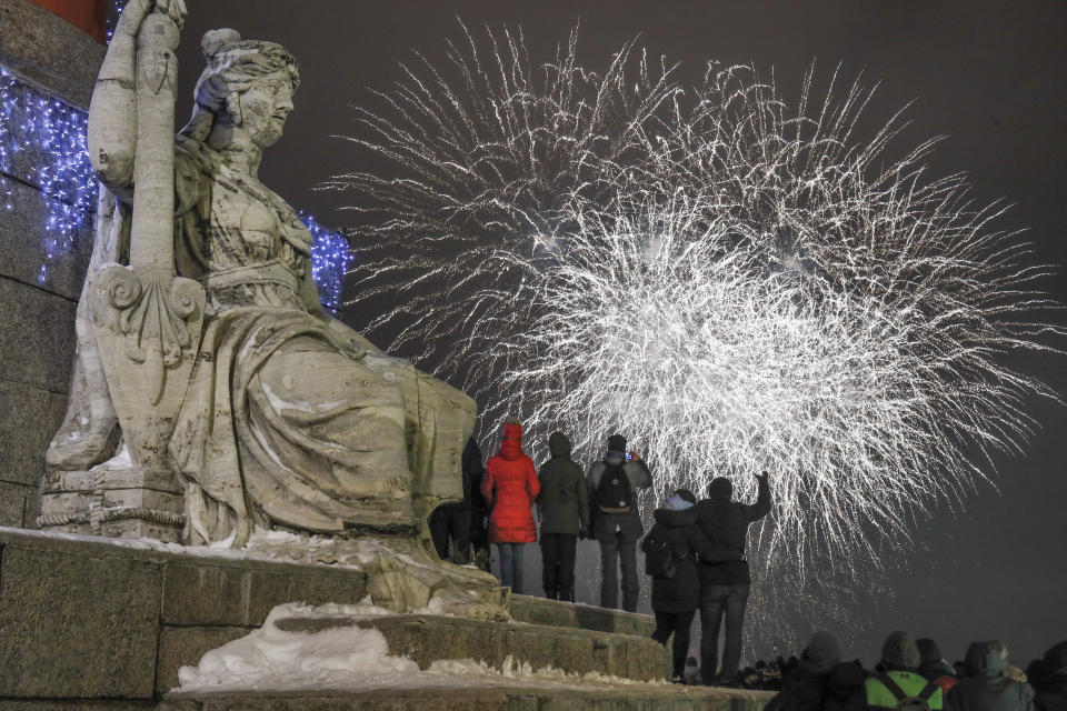 People watch fireworks during New Year celebration in downtown St.Petersburg, Russia, Tuesday, Jan. 1, 2019. (AP Photo/Dmitri Lovetsky)