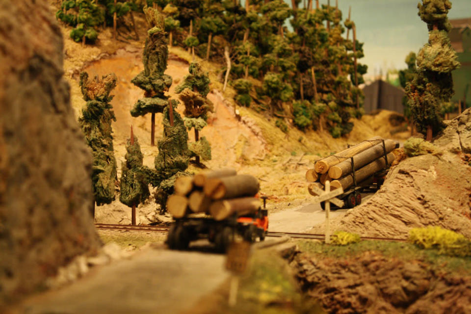 Logging trucks cross over railway tracks. After 67 years in the Liberty Village location, The Model Railroad Club of Toronto will be moving to make way for a condo.