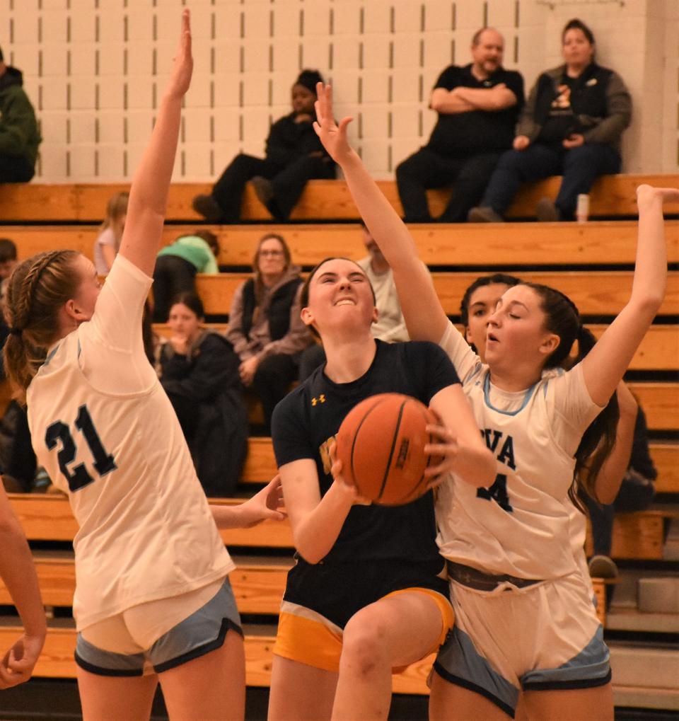 Notre Dame Juggler Ella Trinkaus (20) drives between Central Valley Academy defenders Maeve Brien and Molly Canipe (from left) for a shot during the first half Thursday. Trinkaus scored 17 of her 24 points in the second half of a 41-34 victory.