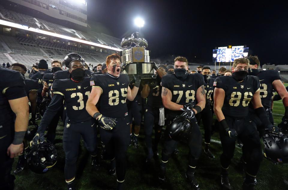Dec 19, 2020; West Point, New York, USA; The Army Black Knights celebrate with the Commander in Chief’s Trophy after beating the Air Force Falcons 10-7 at Michie Stadium. Mandatory Credit: Danny Wild-USA TODAY Sports