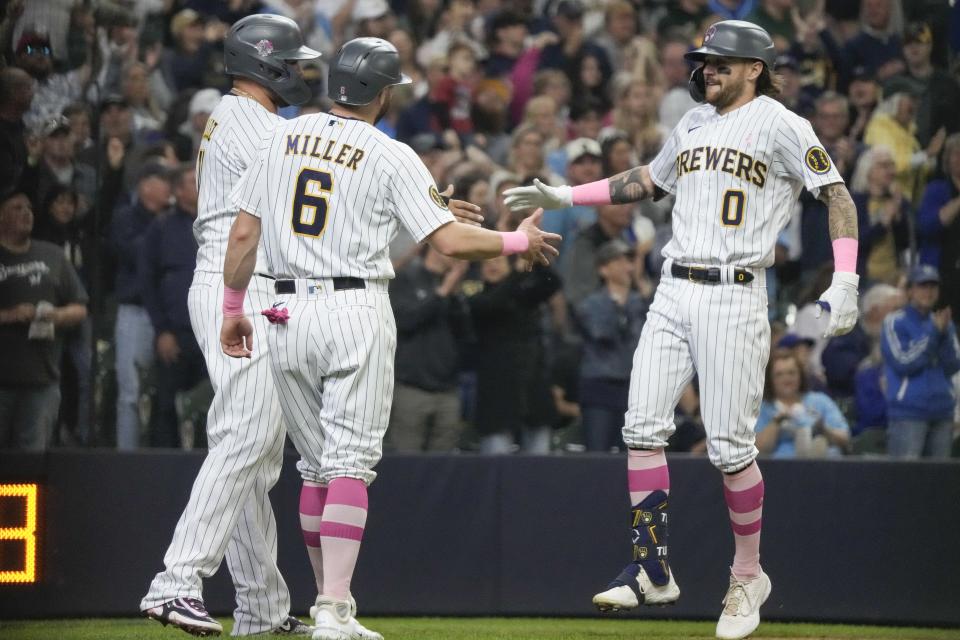 Milwaukee Brewers' Brice Turang is congratulated by Owen Miller and Rowdy Tellez after hitting a three-run home run during the third inning of a baseball game against the Kansas City Royals Sunday, May 14, 2023, in Milwaukee. (AP Photo/Morry Gash)