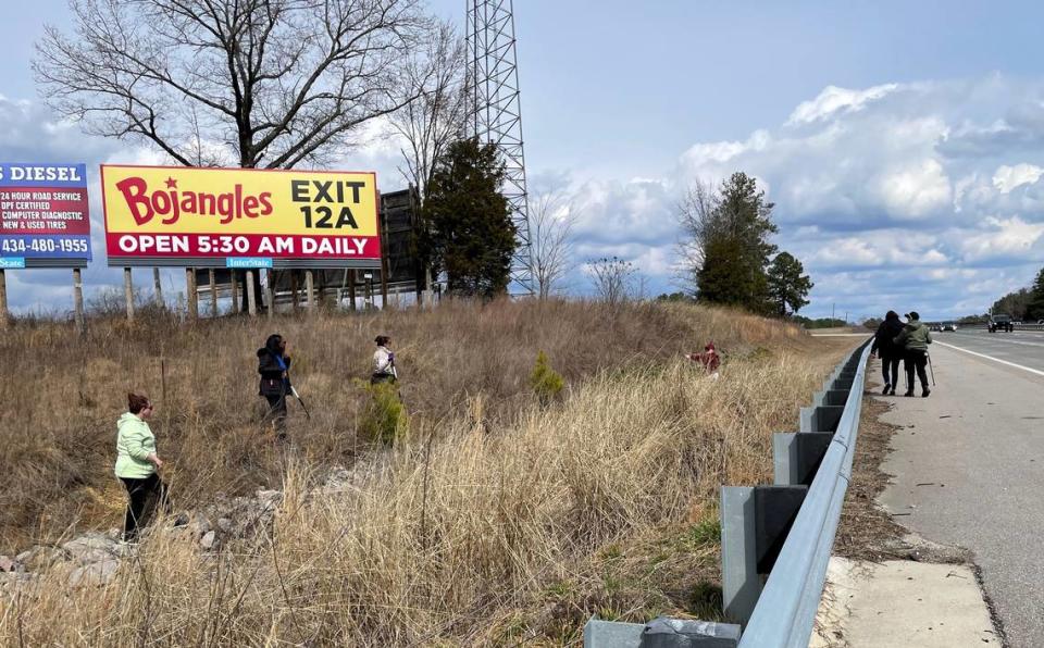 Family members and a friend search a drainage area on the side of Interstate 85, near exit 229, in North Carolina for traces of Alyssa Taylor, a missing woman from Virginia. A medium told the family she may have jumped from a tractor-trailer truck here and died.