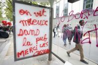 A message is written on an advertising board which was attacked by youths who took part in a demonstration in protest of the government's proposed labour law reforms in Paris, France, May 26, 2016. REUTERS/Charles Platiau