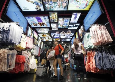 Customers shop at a Primark store on Oxford Street in London June 20, 2014. REUTERS/Luke MacGregor