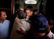 A party worker greets Waseem Akhtar (C), mayor nominee of Muttahida Qaumi Movement (MQM) political party after the ballot for mayor at the Municipal Corporation Building in Karachi, Pakistan, August 24, 2016. REUTERS/Akhtar Soomro