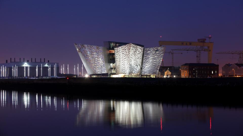 The new Titanic House Vistor centre lights up the skyline in the Titanic quarter, Belfast, Northern Ireland, Sunday, March, 25, 2012. The £100 million (119.5 million euros; $158 million dollars) building is now finished and will open to the public on March 31. The world's biggest Titanic visitor attraction is to open in its Belfast birthplace later this month and it is 100 years to the day since the doomed ocean liner was completed in the same shipyard, Harland and Wolff. Northern Ireland hopes the eye-catching building will boost the tourism economy. (AP Photo/Peter Morrison)