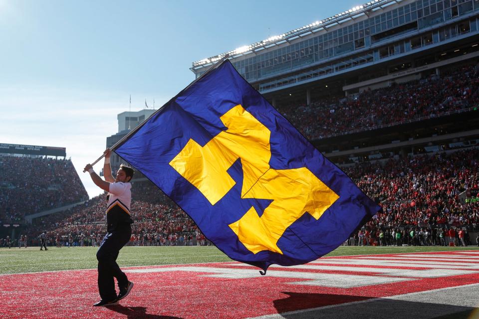 A Michigan cheerleader celebrates a touchdown against Ohio State during the first half Nov. 26, 2022 at Ohio Stadium in Columbus.