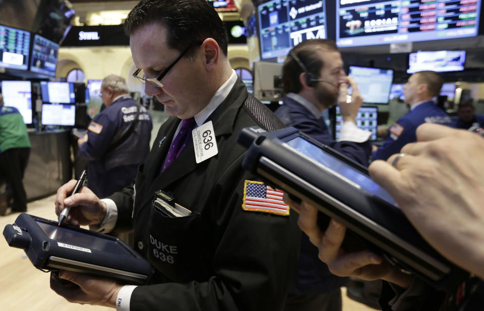 Trader Edward Curran, left, works on the floor of the New York Stock Exchange, Friday, Feb. 28, 2014. U.S. stocks are opening higher, pushing the market further into record territory. (AP Photo/Richard Drew)