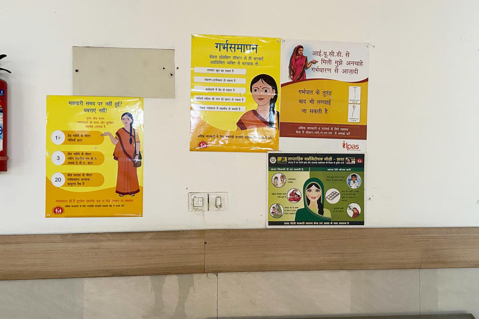 A cluster of posters in Gautam Buddha Nagar District Hospital showcasing a young woman and the family planning services the government provides (Suchitra / NBC News)