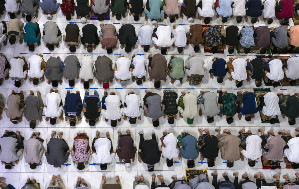Muslim men perform an evening prayer called 'tarawih' marking the first evening of Ramadan despite concerns of the new coronavirus outbreak at the Islamic Centre Mosque in Lhokseumawe, Aceh province, Indonesia, Thursday, April 23, 2020. The coronavirus pandemic is cutting off the world's 1.8 billion Muslims from their cherished Ramadan traditions as health officials battle to ward off new infections during Islam's holiest month, haunted by multiple outbreaks traced to previous religious gatherings. (AP Photo/Zik Maulana)