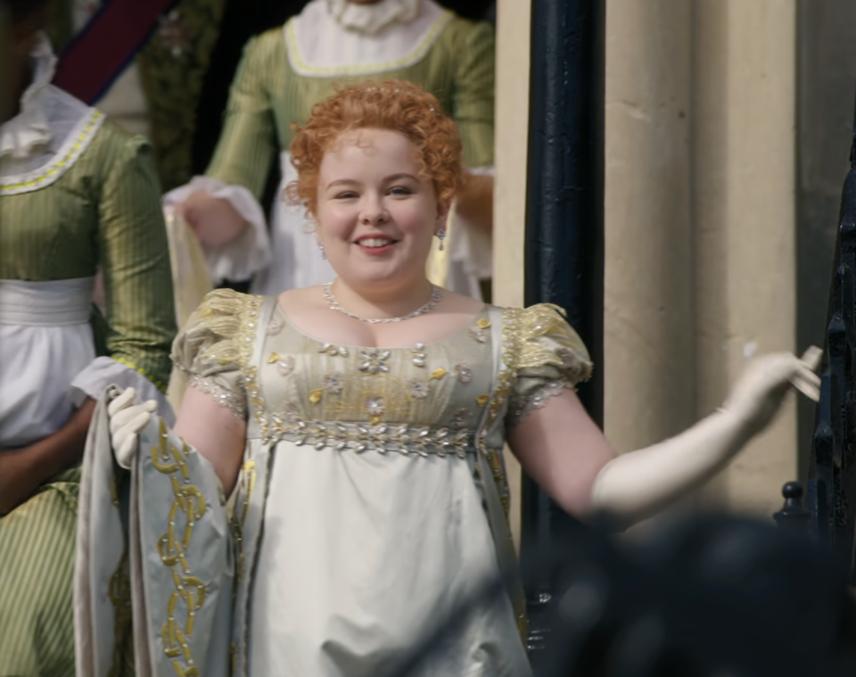 Nicola Coughlan as Penelope Featherington in Bridgerton, wearing a regal Empire-waist gown