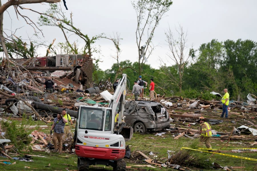 Workers search through the remains of tornado-damaged homes, Tuesday, May 21, 2024, in Greenfield, Iowa. (AP Photo/Charlie Neibergall)