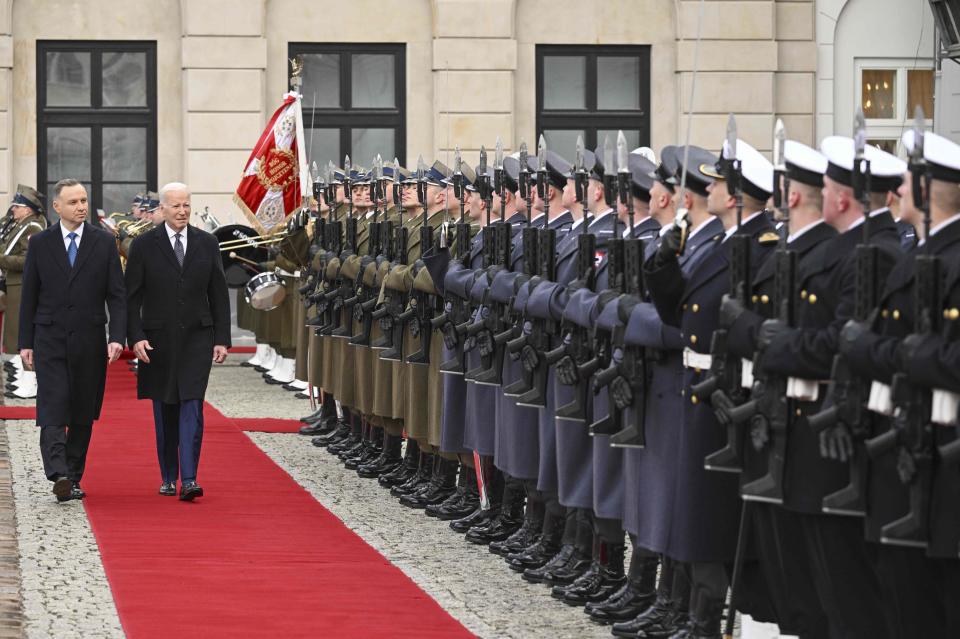 US President Joe Biden (R) and Polish President Andrzej Duda review a military honour guard during a welcoming ceremony prior talks at the Presidential Palace in Warsaw on Feb. 21, 2023.