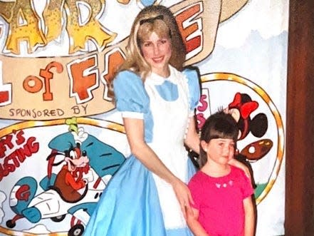 megan posing with alice at disney world as a child 30 years ago