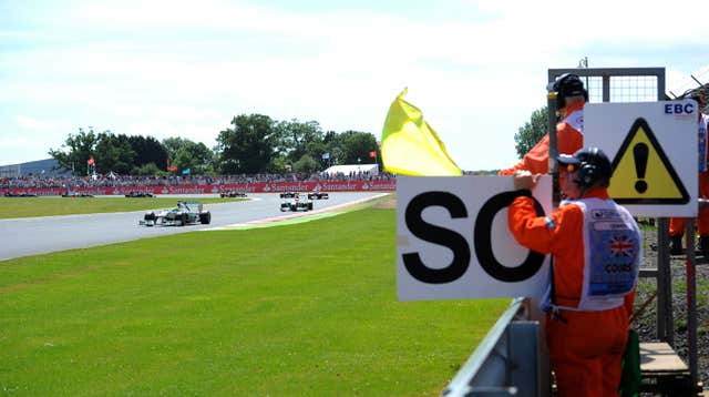 Mercedes’ Nico Rosberg drives by waved yellow flags 