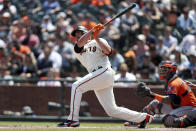 San Francisco Giants' Darin Ruf, left, hits a home run in front of Houston Astros' Martin Maldonado during the fifth inning of a baseball game in San Francisco, Saturday, July 31, 2021. (AP Photo/Jed Jacobsohn)