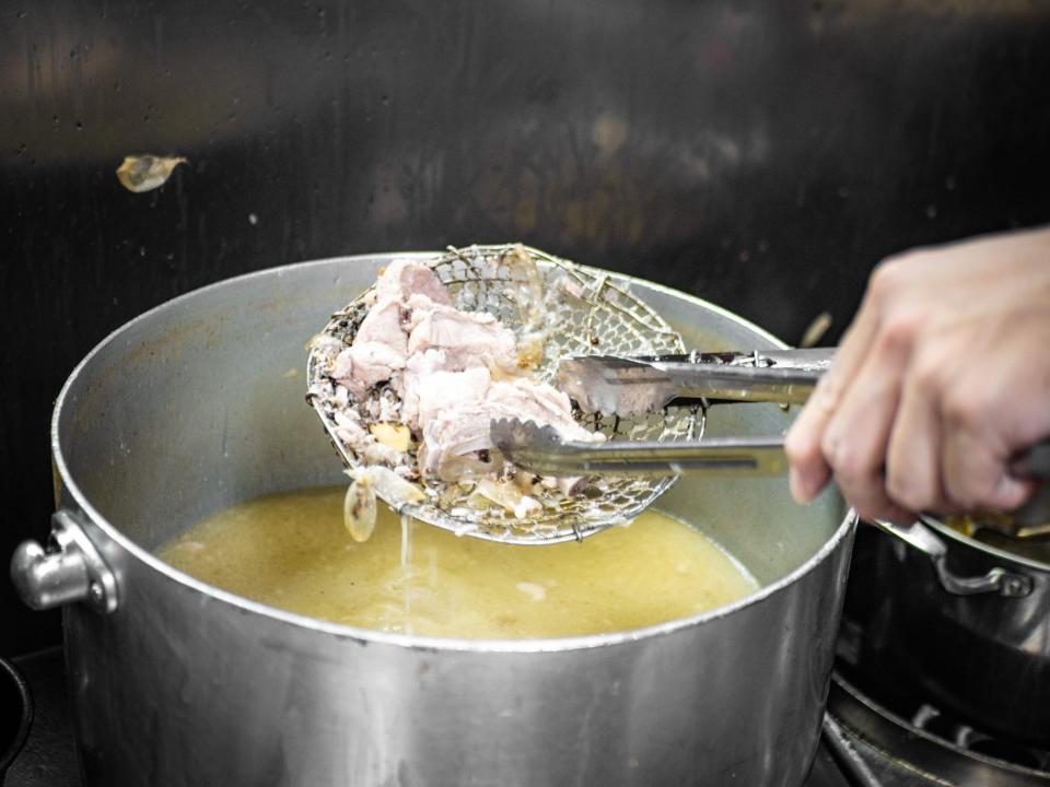 Pork-rib soup being made in a large pot.