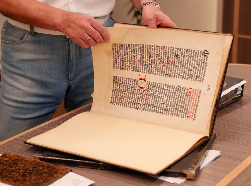 Ukrainian opposition politician Medvedchuk shows a fragment of the Gutenberg Bible during an interview in Kyiv