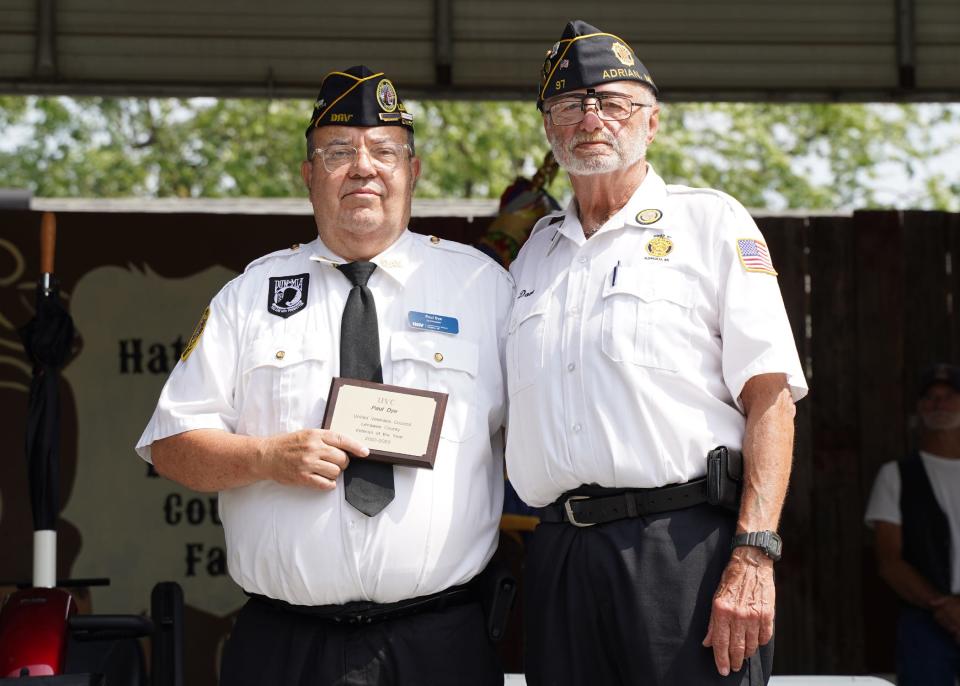 Paul Dye, left, of Disabled American Veterans Chapter 20 in Adrian poses with the Veteran of the Year award and Dave Loop of American Legion Post 97 during the Veterans Day program Wednesday at the Lenawee County Fair.