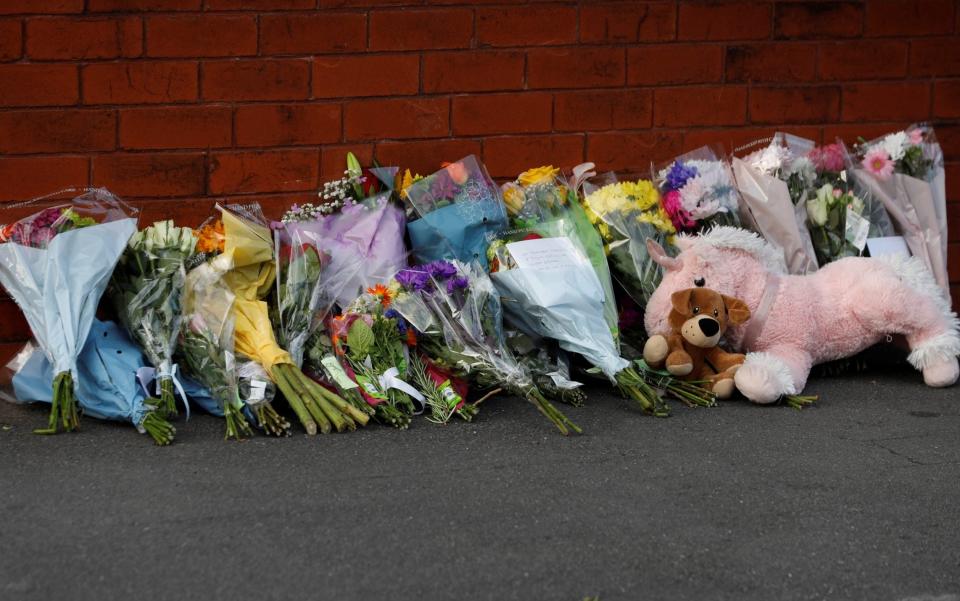 Flowers and a stuffed animals at the scene