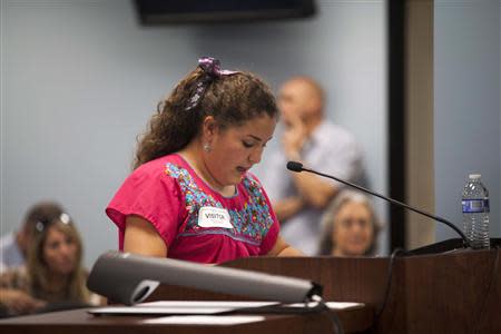 Anna Rose Mohr-Almeida, 11, of Mesa, Arizona, addresses the Arizona Corporations Commission in Phoenix November 13, 2013. REUTERS/Samantha Sais