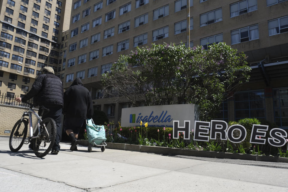 A sign reading "Heroes work here" is displayed in front of the Isabella Center in New York, Tuesday, May 5, 2020. New York state is reporting more than 1,700 previously undisclosed deaths at nursing homes and adult care facilities as the state faces scrutiny over how it's protected vulnerable residents during the coronavirus pandemic. (AP Photo/Seth Wenig)
