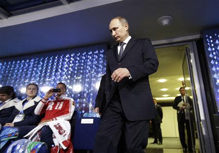 Russian President Vladimir Putin walks out from the presidential lounge to take his seat as he is introduced during the closing ceremony for the 2014 Sochi Winter Olympics, February 23, 2014. REUTERS/David Goldman/Pool