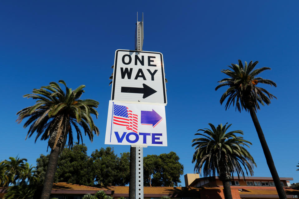 A vote sign points people to a local poling location during midterm elections in Newport Beach, California, U.S. November 6, 2018. REUTERS/Mike Blake