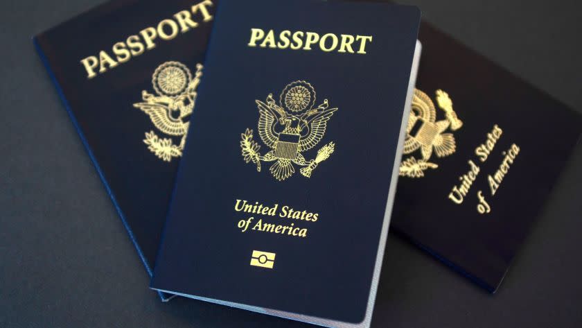 In this May 9, 2017 photo, U.S. passports lie on a table in Dallas, Texas. The U.S. State Department is in the middle of a record year for processing passport applications, with 20.5 million renewals and applications for new passports expected. Adult U.S. passports must be renewed every 10 years, and the 2017 surge comes a decade after a law went into effect requiring passports for U.S. citizens traveling to Mexico, Canada and the Caribbean. (AP Photo/Benny Snyder)