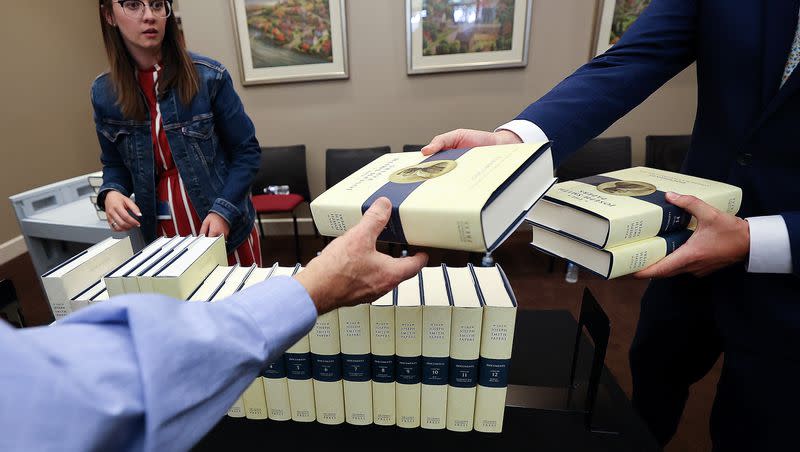 Brooke Jurges, publications administrative assistant, watches a handoff of Volume 15 of the Joseph Smith Papers during a Church History Department event to commemorate the final print volume of the Joseph Smith Papers at the Church History Library in Salt Lake City on Tuesday, June 27, 2023.