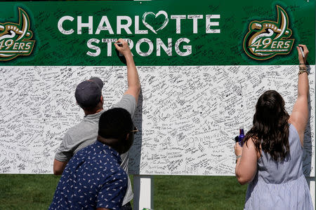 FILE PHOTO: Patrons sign a board to show their sentiments in support of UNC Charlotte after the recent shooting deaths during the second round of the Wells Fargo Championship golf tournament at the Quail Hollow Club in Charlotte, North Carolina, U.S., May 3, 2019. Mandatory Credit: Jim Dedmon-USA TODAY Sports/File Photo