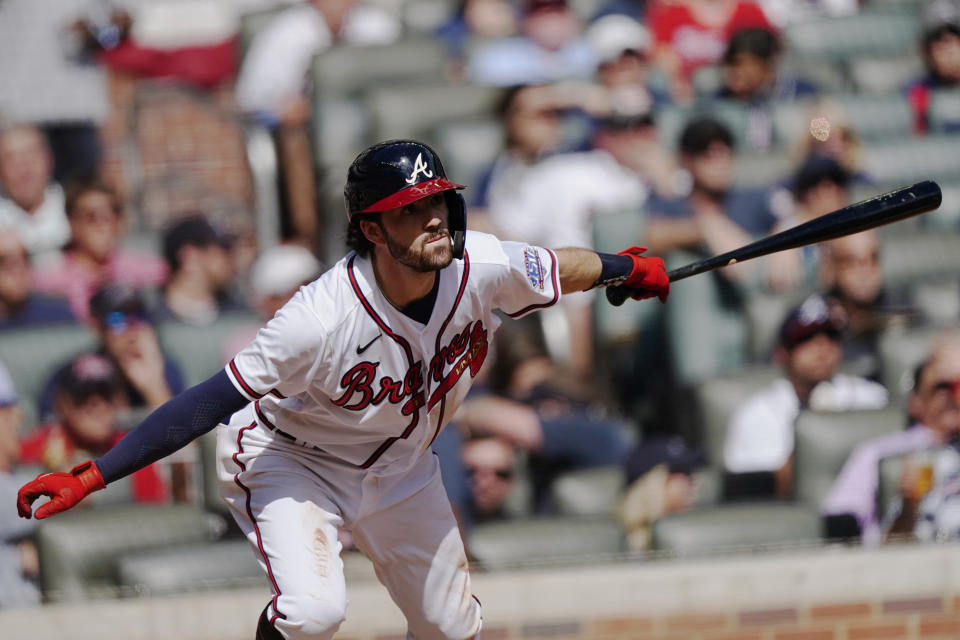Atlanta Braves' Dansby Swanson (7) follows through on a single during the fifth inning of Game 3 of a baseball National League Division Series against the Milwaukee Brewers, Monday, Oct. 11, 2021, in Atlanta. (AP Photo/John Bazemore)