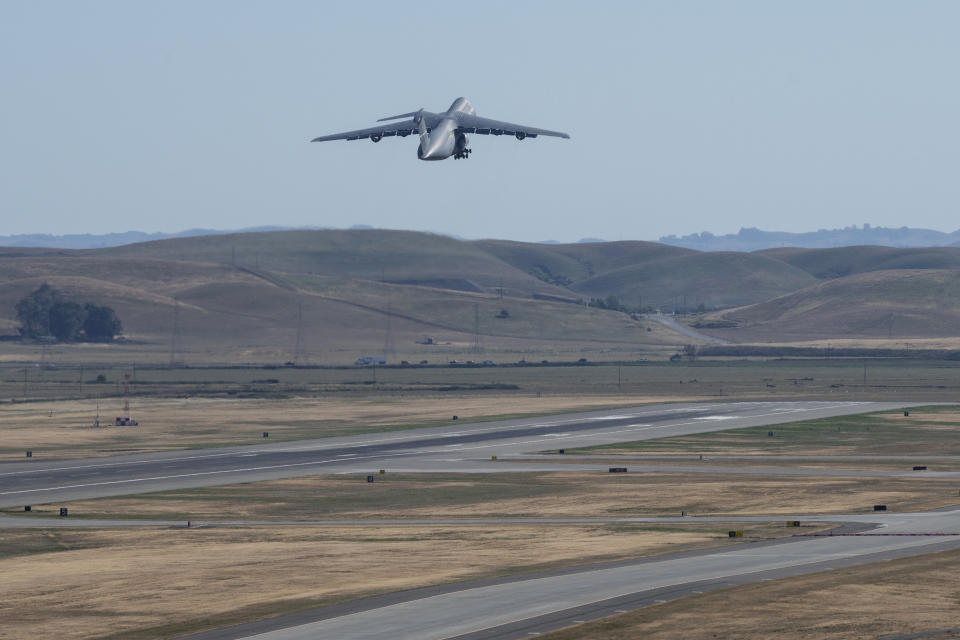 In this photo provided by the U.S. Air Force, a C-5M Super Galaxy, carrying critical medical supplies, takes off Wednesday, April 28, 2021, from Travis Air Force Base, Calif., for a non-stop flight to India. The United States is donating medical supplies to assist the country of India in its ongoing fight against COVID-19. The donation consisted of 440 oxygen cylinders and regulators, one million N-95 masks and one million COVID-19 rapid diagnostic kits. (Cameron Otte/U.S. Air Force via AP)