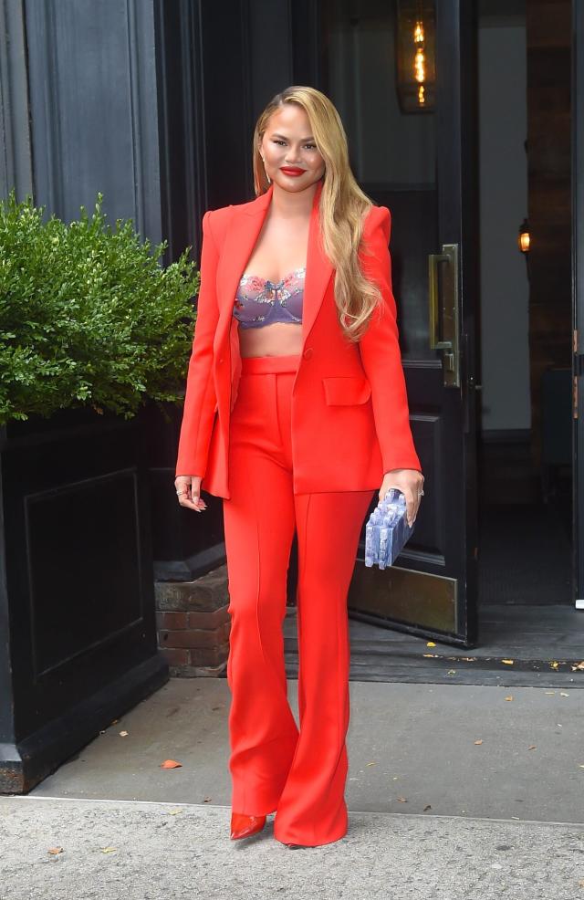 Chrissy Teigen Wore a Floral Bra Under a Bright Red Suit