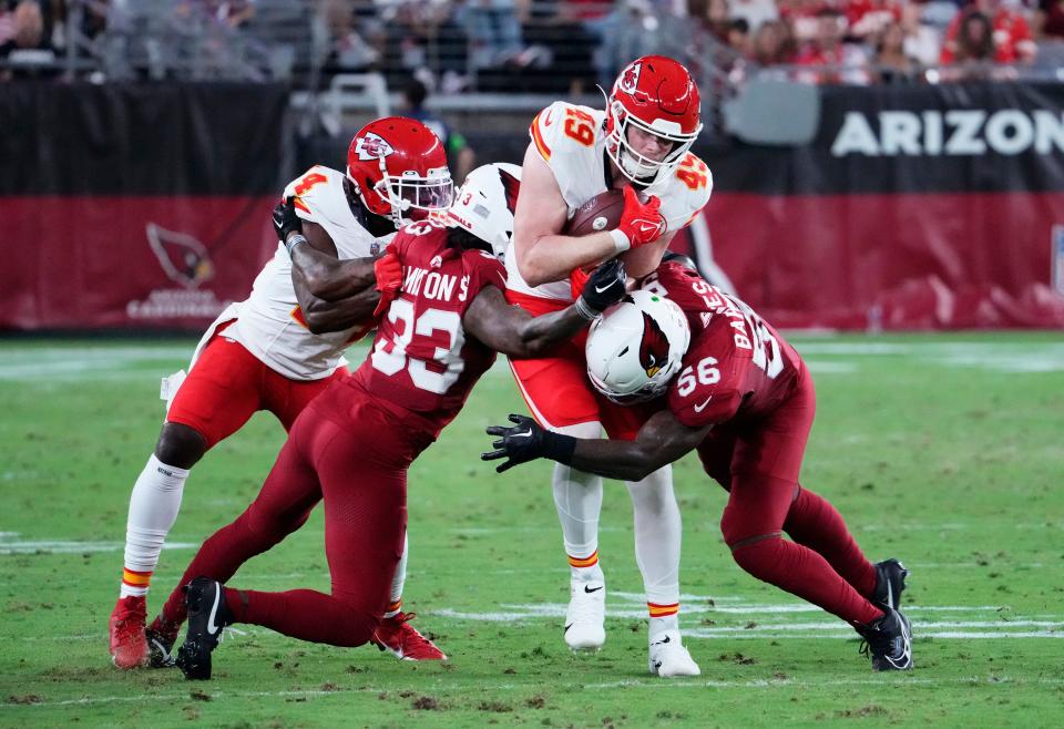Arizona Cardinals linebacker <a class="link " href="https://sports.yahoo.com/nfl/players/33221" data-i13n="sec:content-canvas;subsec:anchor_text;elm:context_link" data-ylk="slk:Krys Barnes;sec:content-canvas;subsec:anchor_text;elm:context_link;itc:0">Krys Barnes</a> (56) tackles <a class="link " href="https://sports.yahoo.com/nfl/teams/kansas-city/" data-i13n="sec:content-canvas;subsec:anchor_text;elm:context_link" data-ylk="slk:Kansas City Chiefs;sec:content-canvas;subsec:anchor_text;elm:context_link;itc:0">Kansas City Chiefs</a> tight end <a class="link " href="https://sports.yahoo.com/nfl/players/33804" data-i13n="sec:content-canvas;subsec:anchor_text;elm:context_link" data-ylk="slk:Matt Bushman;sec:content-canvas;subsec:anchor_text;elm:context_link;itc:0">Matt Bushman</a> (49) in the first half during a preseason game at State Farm Stadium in Glendale on Aug. 19, 2023.