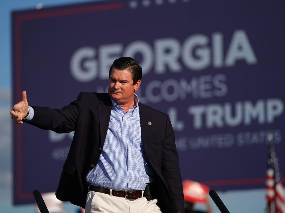 Rep. Austin Scott, a Republican from Georgia, walks off the stage at a rally featuring former US President Donald Trump on September 25, 2021 in Perry, Georgia. Republican Senate candidate Herschel Walker, Georgia Secretary of State candidate Rep. Jody Hice (R-GA), and Georgia Lieutenant Gubernatorial candidate State Sen. Burt Jones (R-GA) also appeared as guests at the rally.