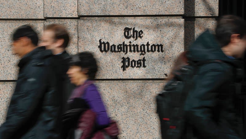 People walk by the One Franklin Square Building, home of The Washington Post newspaper, in downtown Washington, Feb. 21, 2019. New leaders of The Washington Post are being haunted by their past, with ethical questions raised about their actions as journalists in London that illustrate very different press traditions in the United States and England.