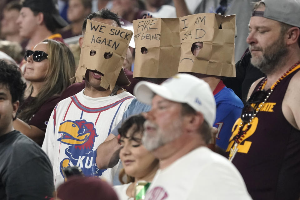 Kansas fans let their thoughts be known as while wearing paper bags on their heads during the second half of an NCAA college football game against the Arizona State Saturday, Oct. 5, 2024, in Tempe, Ariz. (AP Photo/Darryl Webb)