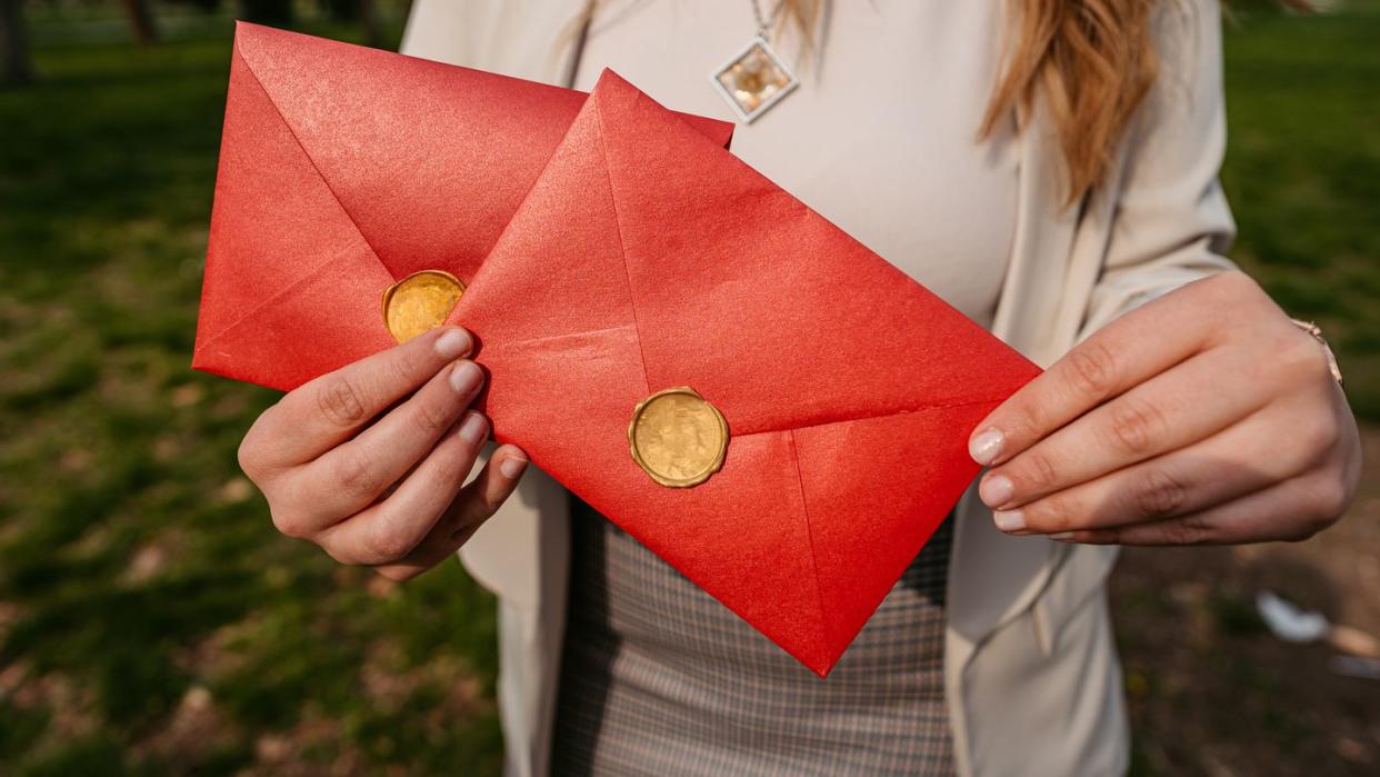 young woman holding envelopes