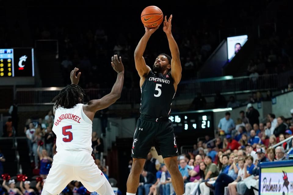 Mar 3, 2022; Dallas, Texas, USA;  Cincinnati Bearcats guard David DeJulius (5) shoots over Southern Methodist Mustangs guard Emmanuel Bandoumel (5) during the first half at Moody Coliseum.