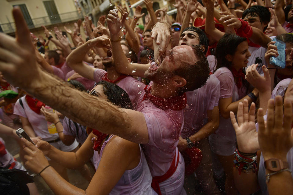 <p>Revelers party after the launching of the <em>chupinazo</em> rocket to celebrate the official opening of the 2017 San Fermín Fiestas in Pamplona, Spain, on July 6. The first of eight days of the Running of the Bulls along the streets of the old quarter of Pamplona starts Friday. (Photo: Alvaro Barrientos/AP) </p>